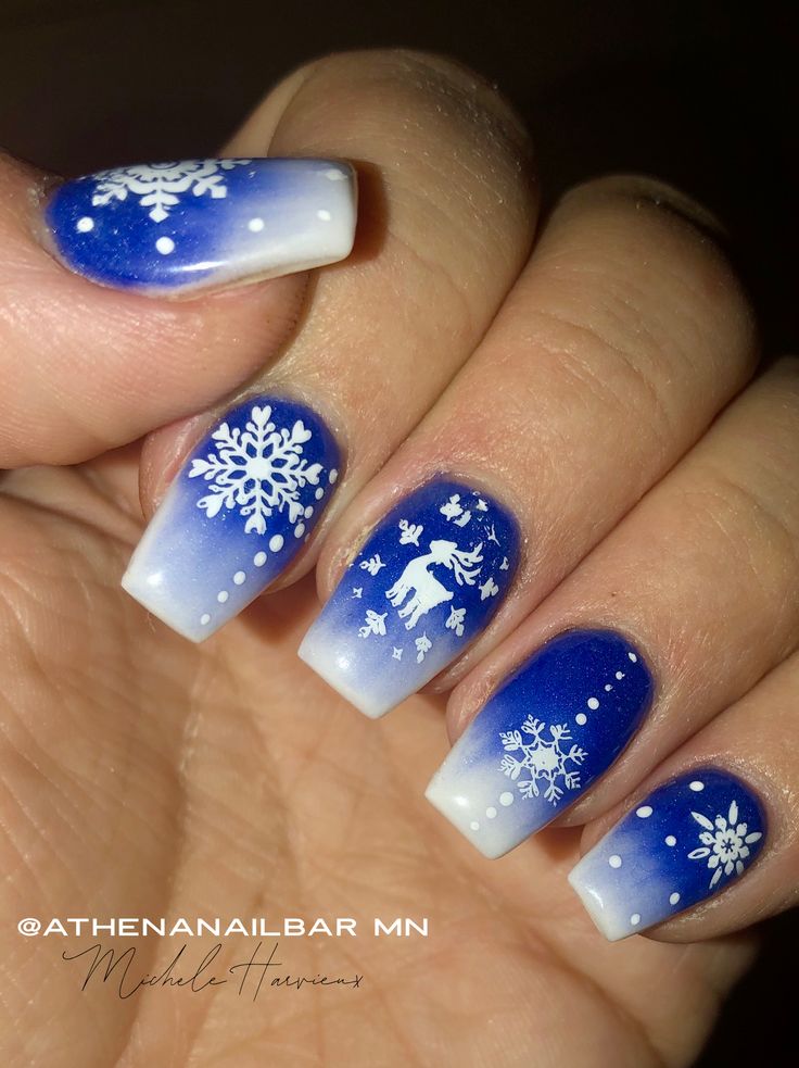 Elegant Winter Nail Design with Blue Gradient, Snowflakes, and Festive Motifs.