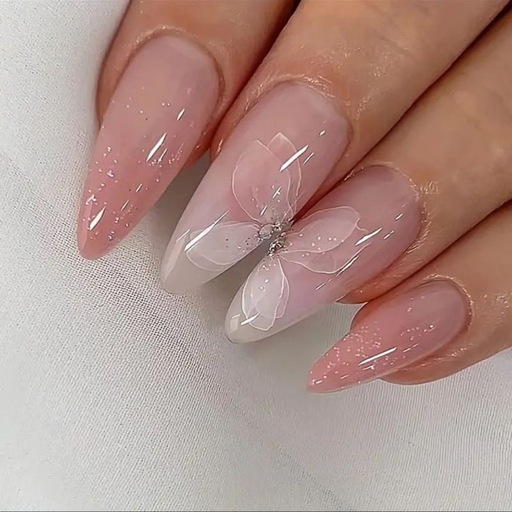 Elegant Nude Gradient Nail Design with Butterfly Accent and Glitter Accents.