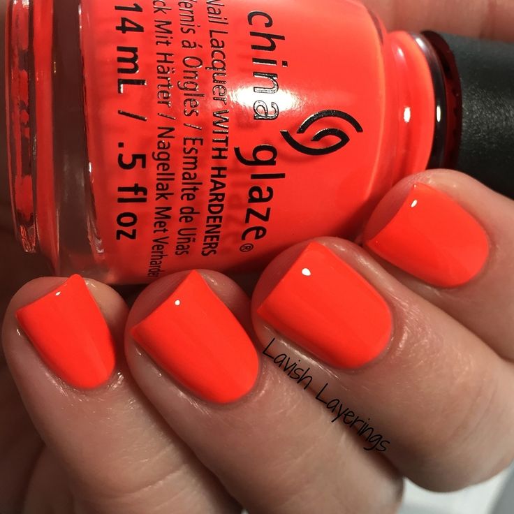 Playful Vibrant Coral Nail Design: A Glossy Modern Summer Manicure.