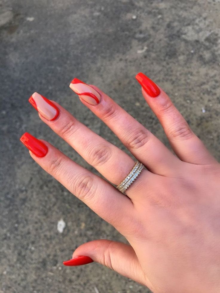 Chic Vibrant Red Nail Design with Marbled Accents and Sparkling Ring.