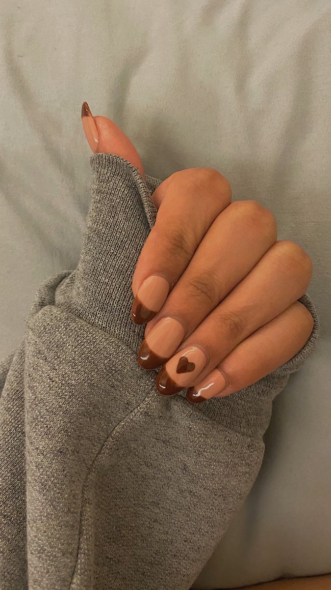 Elegant Chic Nail Design with Warm Browns and Playful Heart Accent.