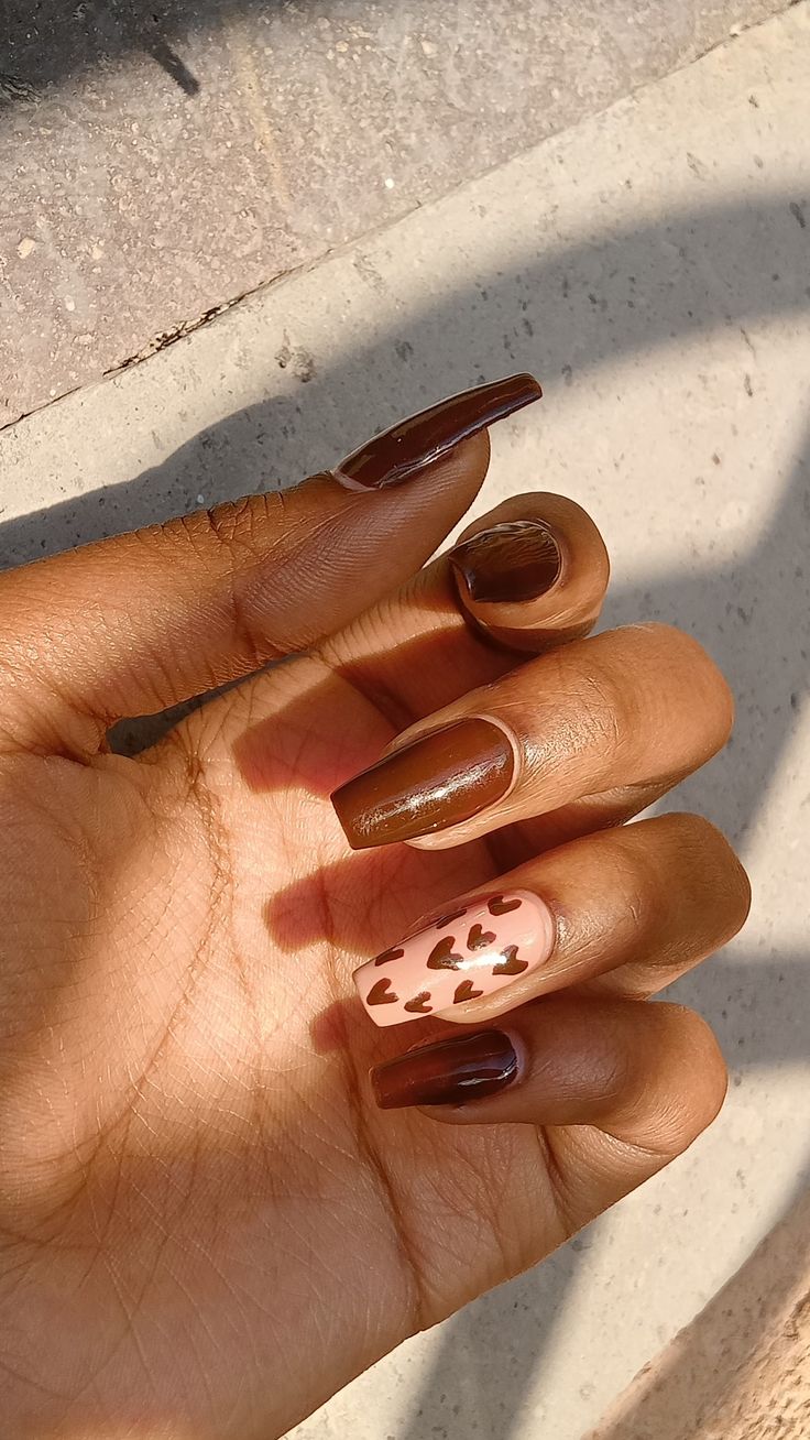 Elegant Chic Brown Nail Design with Playful Heart Accent.