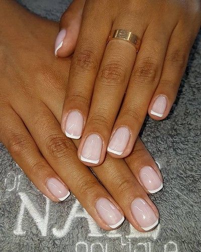 Elegant French Manicure with Soft Pink Base, White Tips, and Chic Gold Jewelry.