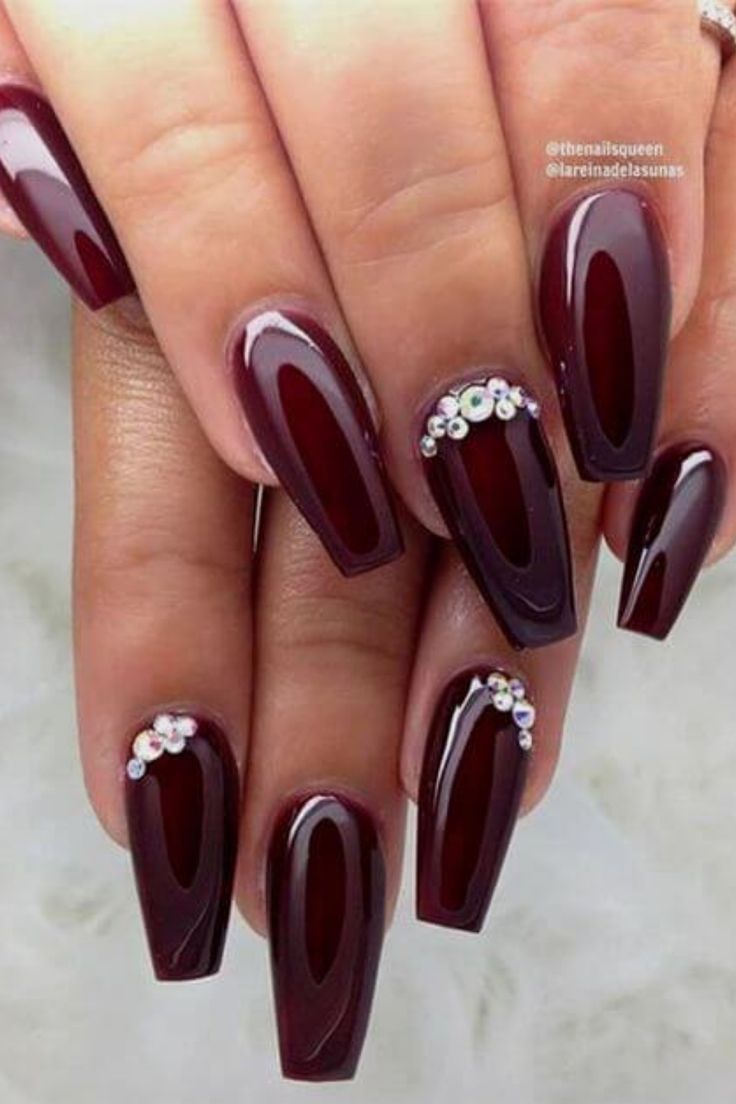 Sophisticated Burgundy Nails with Shimmering Rhinestones for a Luxurious Look.