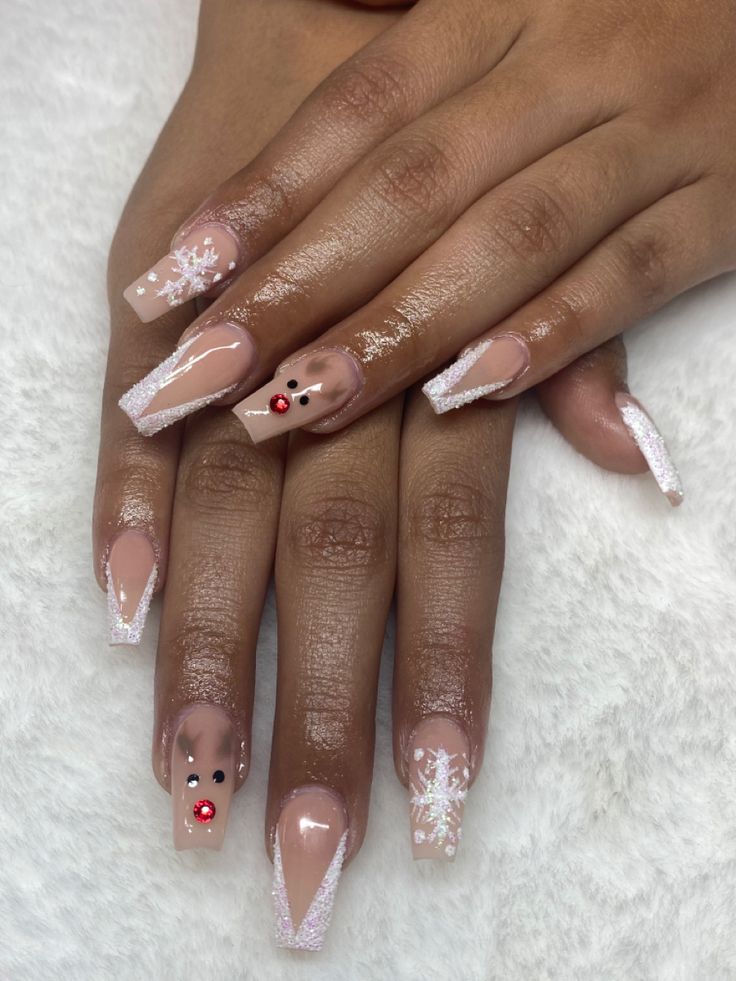 Elegant and Playful Festive Nail Design: Nude Base with Shimmering Tips, Intricate Snowflakes, and Whimsical Reindeer Motif.