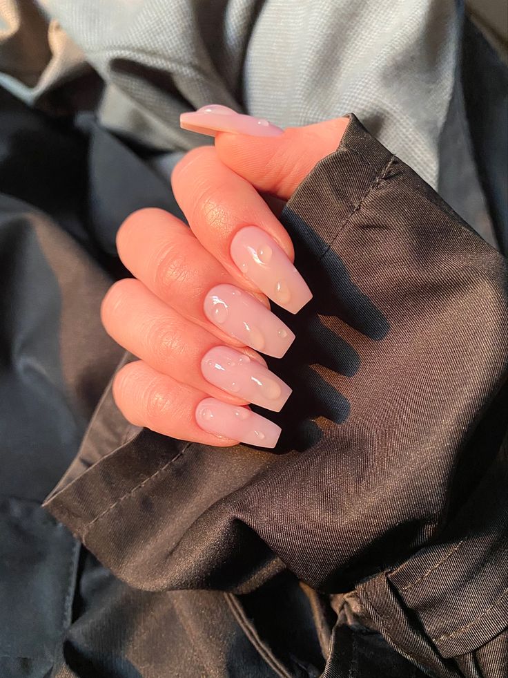 Sleek Nude Nails with Glossy Finish and Unique Bubble Accents for Effortless Elegance.