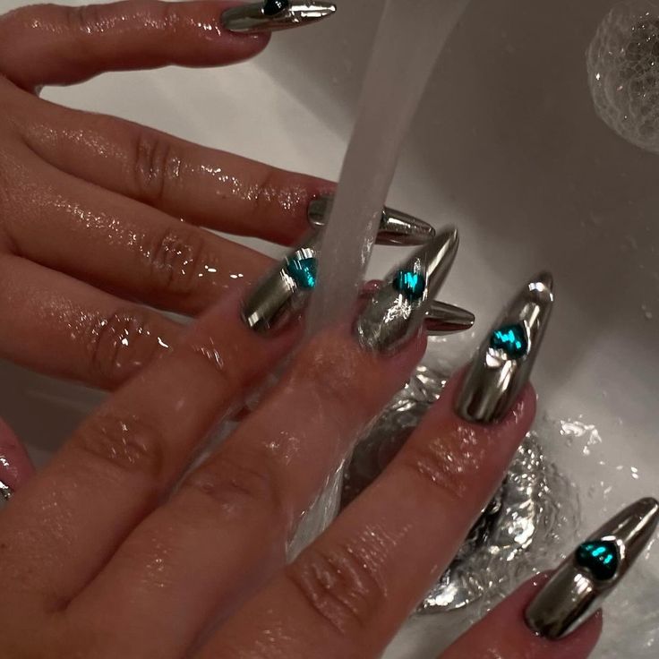 Bold Chrome Finish Nails with Teal Accents for a Striking Statement Design.