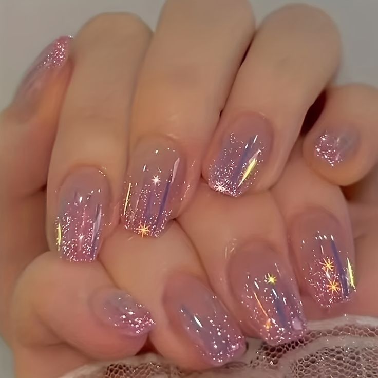 Ethereal Sparkling Ombre Nails: A Dreamy Blend of Soft Pinks and Glitter Accents.