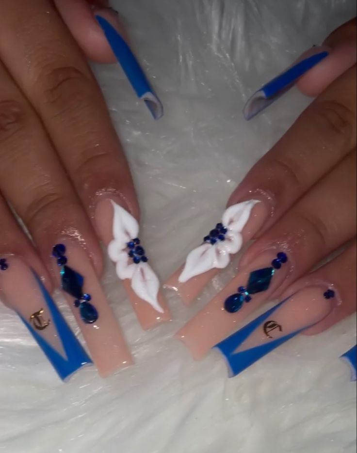 Chic Nail Design with Blue Accents, Floral Embellishments, and Geometric Details.