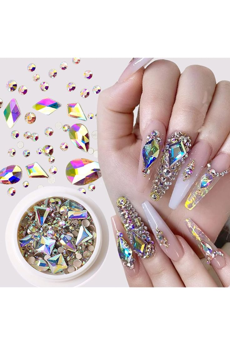 Elegant Nail Art Design: Long, Pointed Nails Adorned with Iridescent Rhinestones and Sophisticated Polish