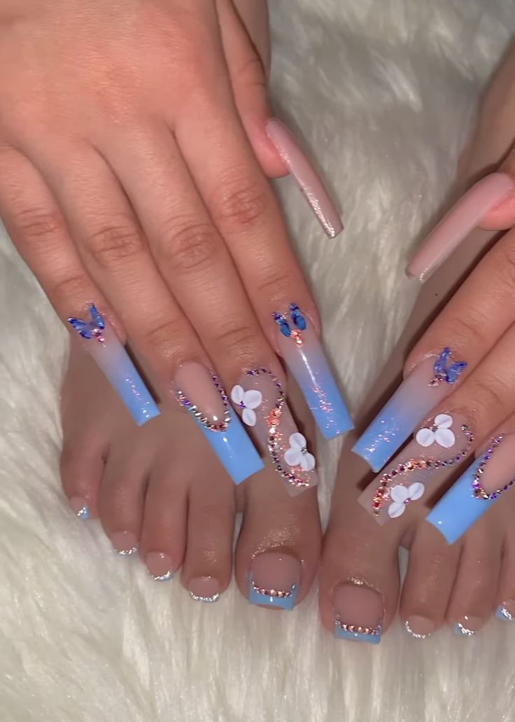 Elegant Gradient Blue Nail Design with Playful Butterfly and Floral Accents.