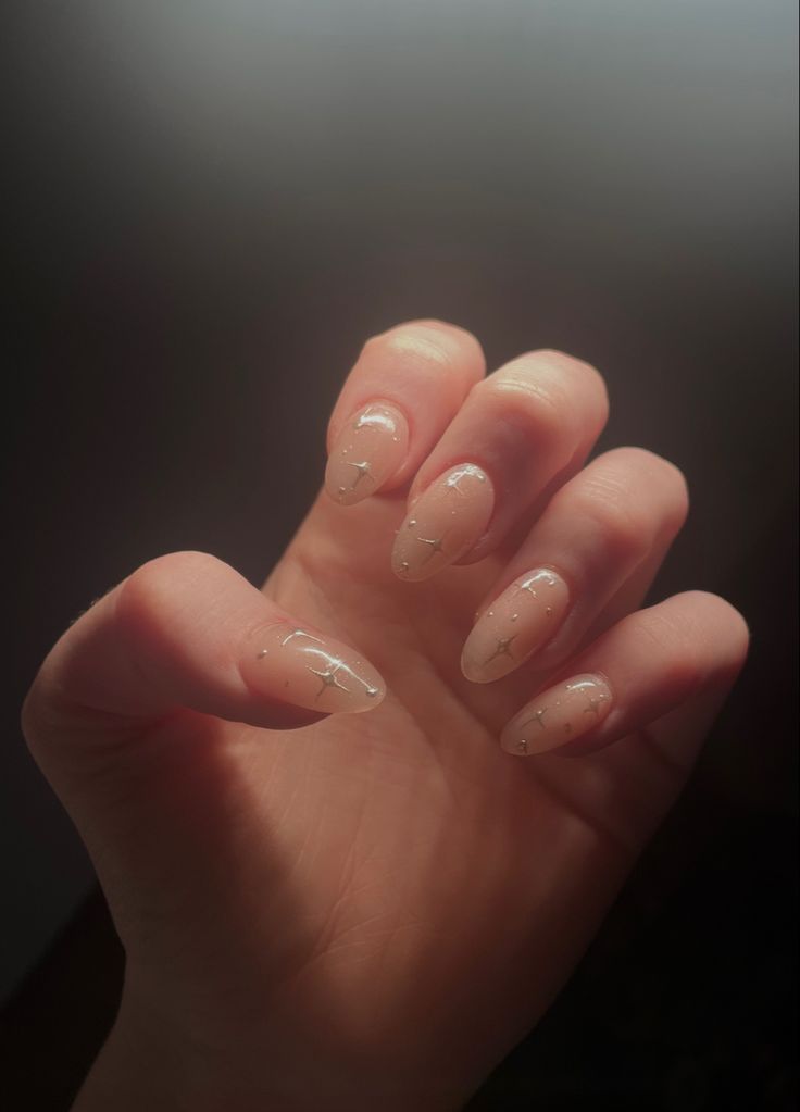 Sophisticated Almond-Shaped Nude Nails with Chic Silver Accents.