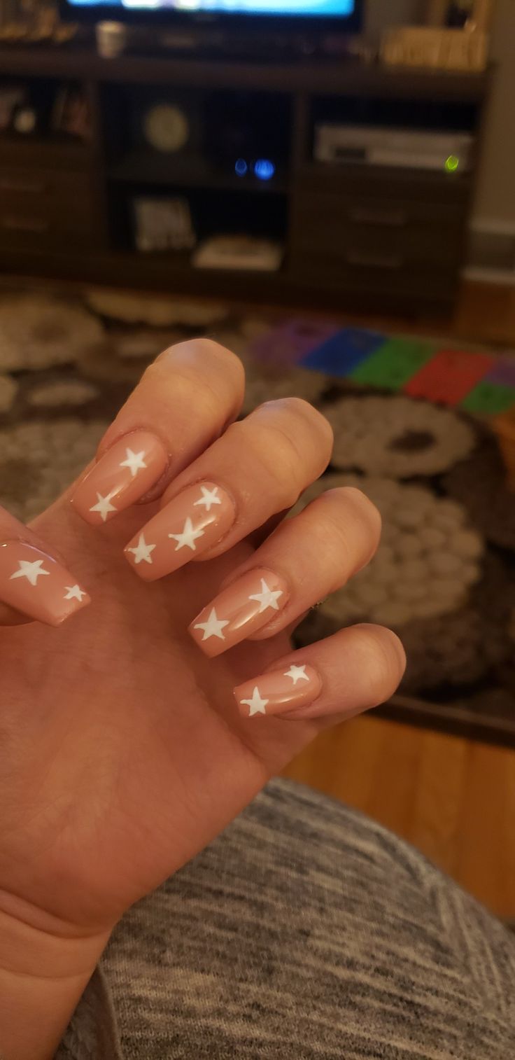 Whimsical Starry Nail Design with Soft Nude Base for Trendy Flair.