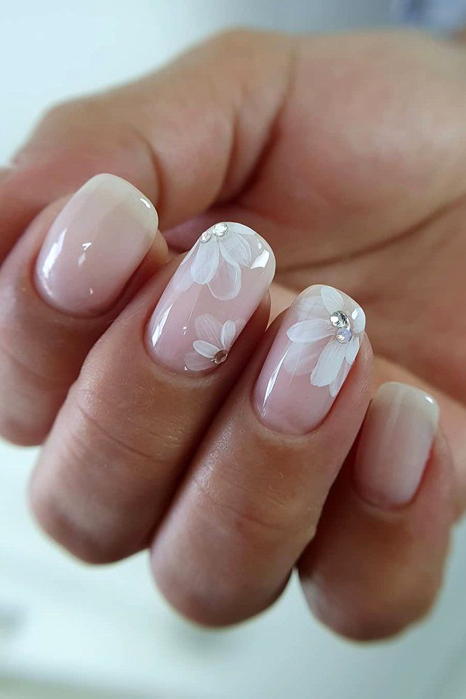 Elegant Floral Nail Design: Soft White Petals on a Natural Nude Background