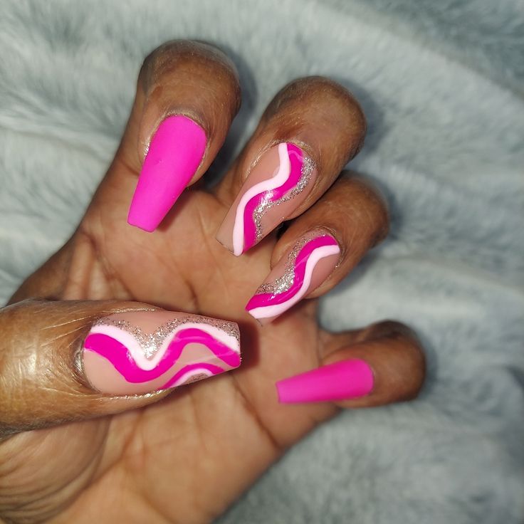 Vibrant Pink and Nude Bold Nail Design with Curvy Patterns and Sparkling Accents.