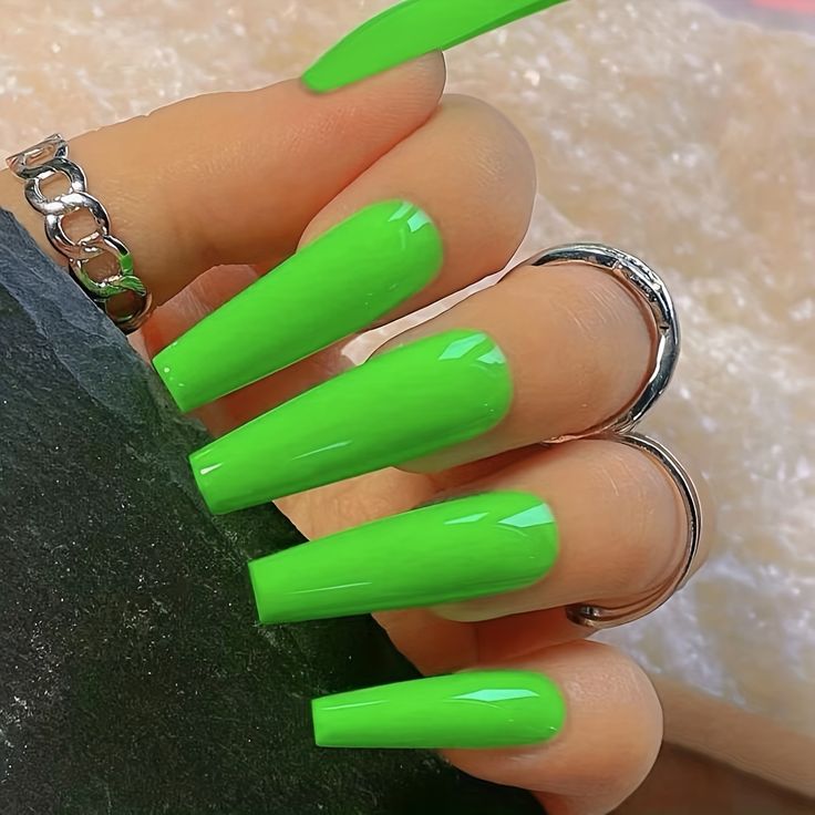 Bold Lime Green Nails with Glossy Finish and Silver Accents for a Trendy Look