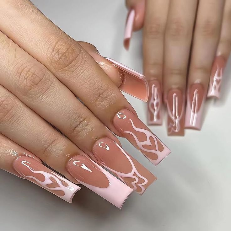 Elegant Pink and Nude Nail Design with Abstract Patterns and Glossy Finish.