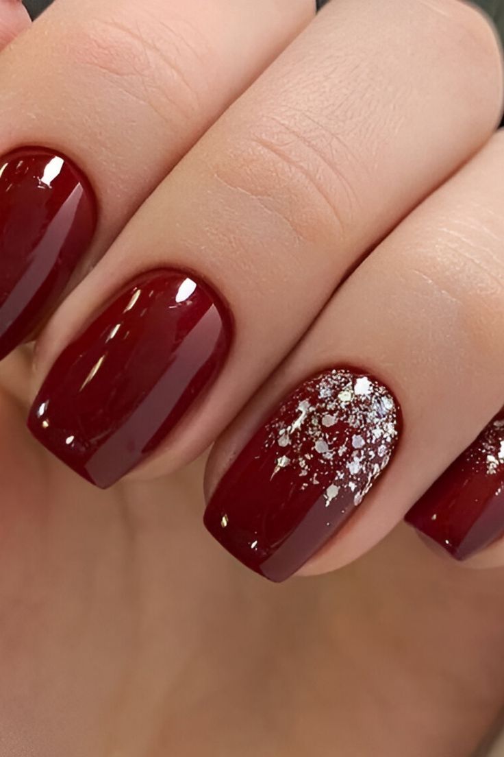 Sophisticated Elegance: Glossy Red Manicure with Glamorous Sparkly Accent.