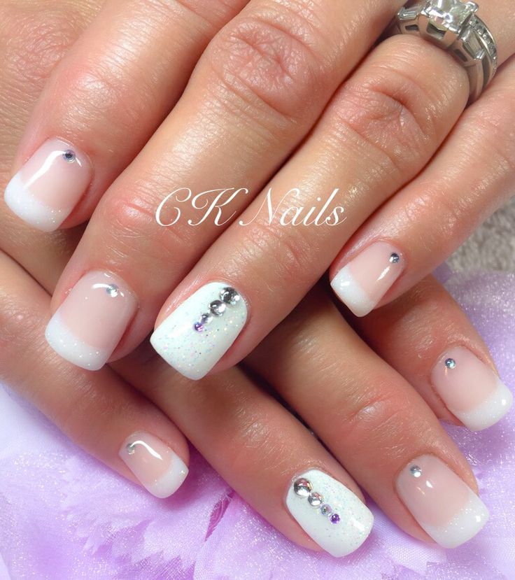 Sophisticated Elegant French Manicure with Rhinestones and Shimmering Tips.