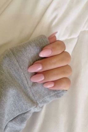 Chic Soft Pink Almond Nails Elevate Cozy Gray Sweater Style.