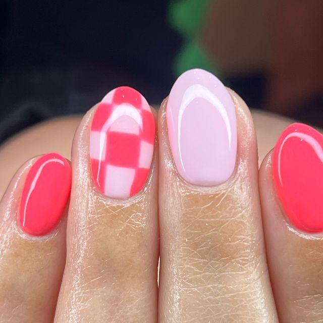 Vibrant Nail Design: Bold Colors and Playful Checkered Pattern for a Trendy Look.