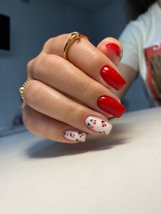 Chic Red and White Nail Design with Cherry Blossom Accents and Gold Ring Glam.