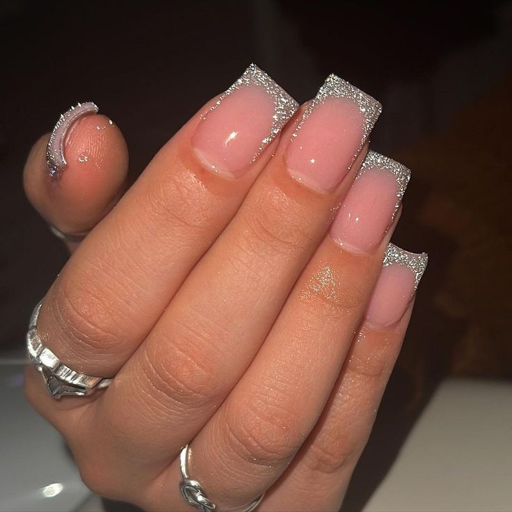 Stylish French Tip Nail Design with Shimmering Silver Glitter and Soft Pink Base