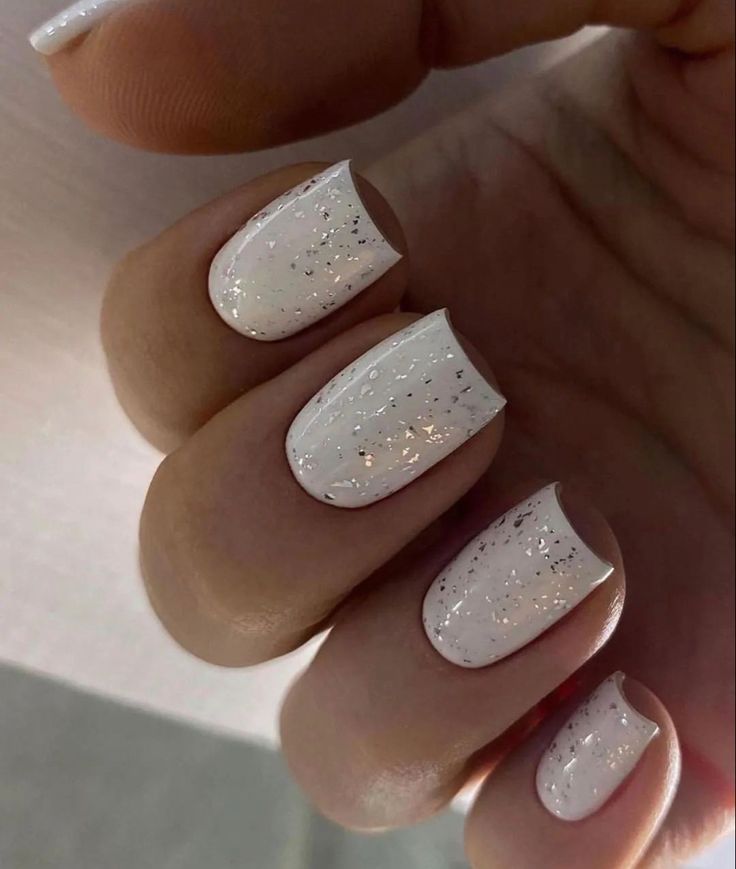 Elegant Sparkling White Nail Design with Glossy Finish and Iridescent Glitter Accents