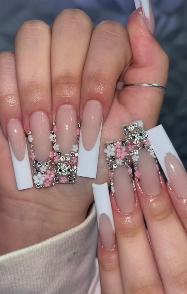 Chic Elegant Nail Design: Soft Nude and White Tips with Floral and Rhinestone Embellishments