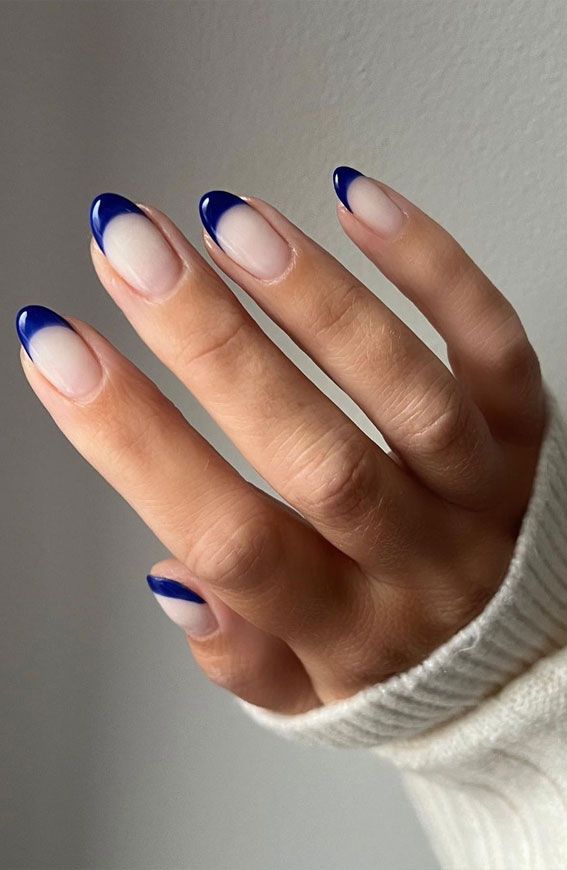 Chic Nail Design: Modern French Manicure with Bold Blue Tips.