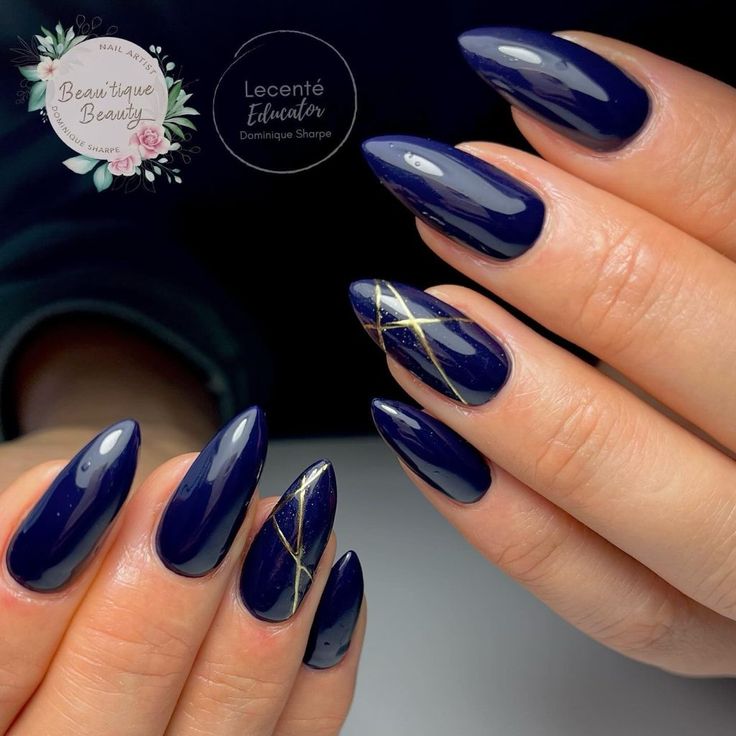 Elegant Navy Almond Nails with Glossy Finish and Golden Geometric Accents.