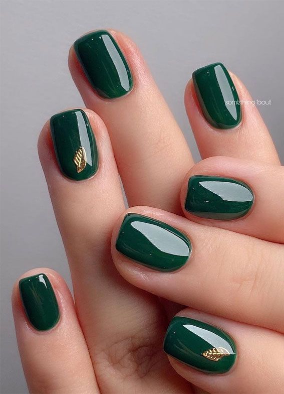 Sophisticated Elegant Green Manicure with Glossy Finish and Gold Accent.