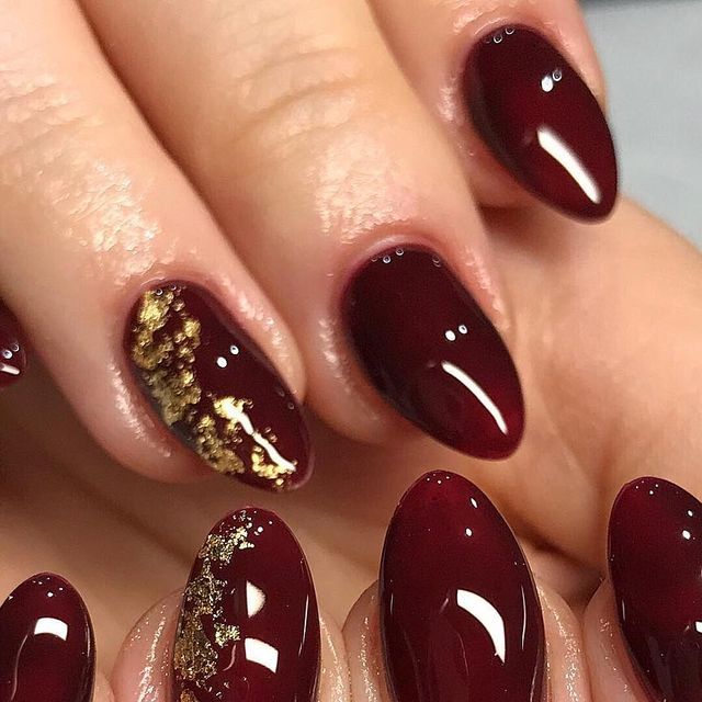 Chic Burgundy Nails with Glossy Finish and Gold Accents for a Bold, Elegant Look.