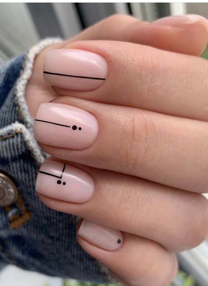 Chic Minimalist Nail Design: Nude Base with Sleek Black Geometric Patterns.