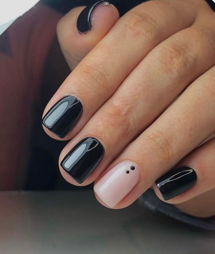 Chic Black and Nude Nail Design: A Modern Aesthetic with Minimalist Dot Detailing.