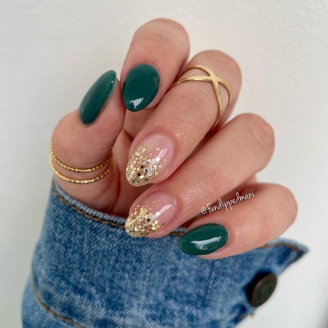 Elegant Almond-Shaped Nail Design: Dark Green and Shimmering Gold Accents for Any Occasion.