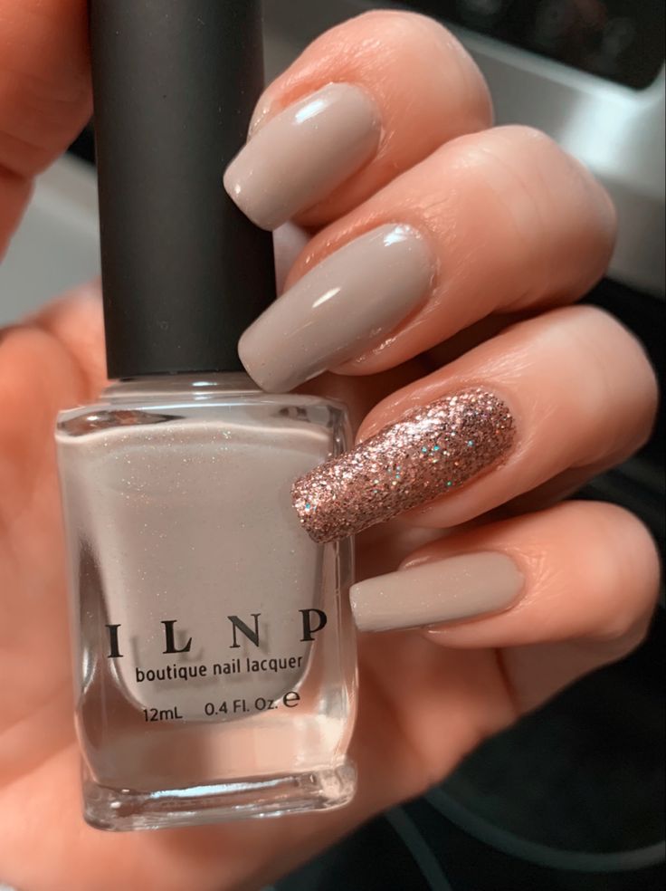 Chic Nude Nail Design with Glitter Accent for Understated Elegance.