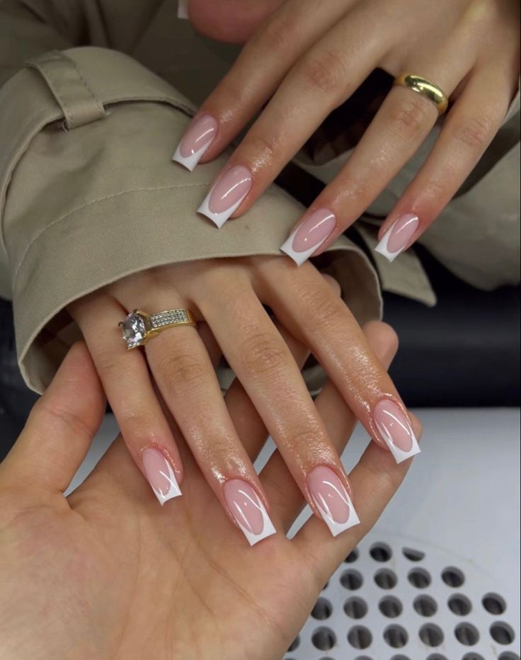 Chic Pale Pink Acrylic Nails with Striking White Tips: A Sophisticated Accessory for Any Occasion.