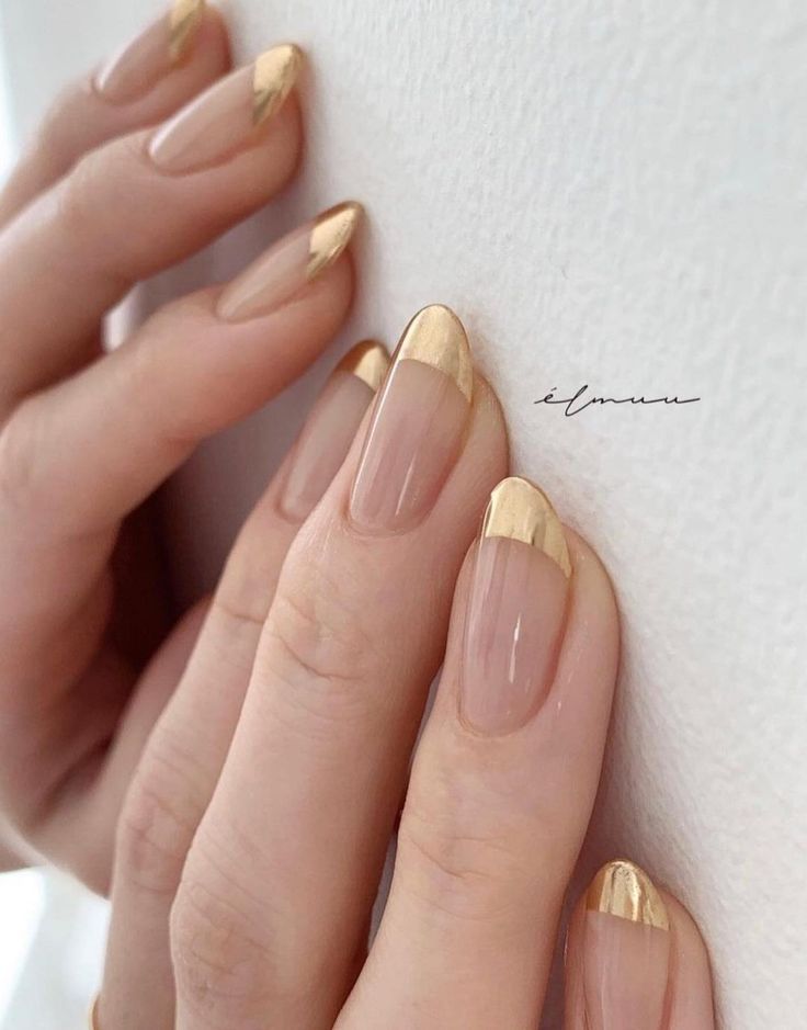 Chic Nude Nail Design with Striking Gold French Tips: A Minimalist Glamour.