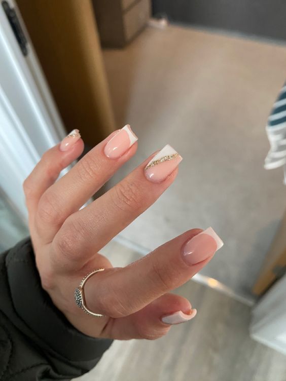 Chic Soft Pink French Tip Nails with Glamorous Crystal Accents.