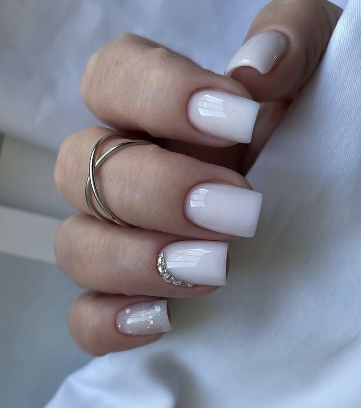 Chic White Nail Design with Glossy Square Tips and Rhinestone Accents.