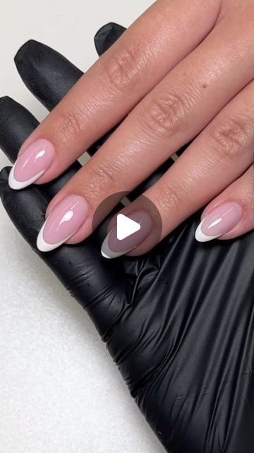 Modern Elegant French Manicure with Glossy Soft Pink and Bold White Tips in Sleek Almond Shape.