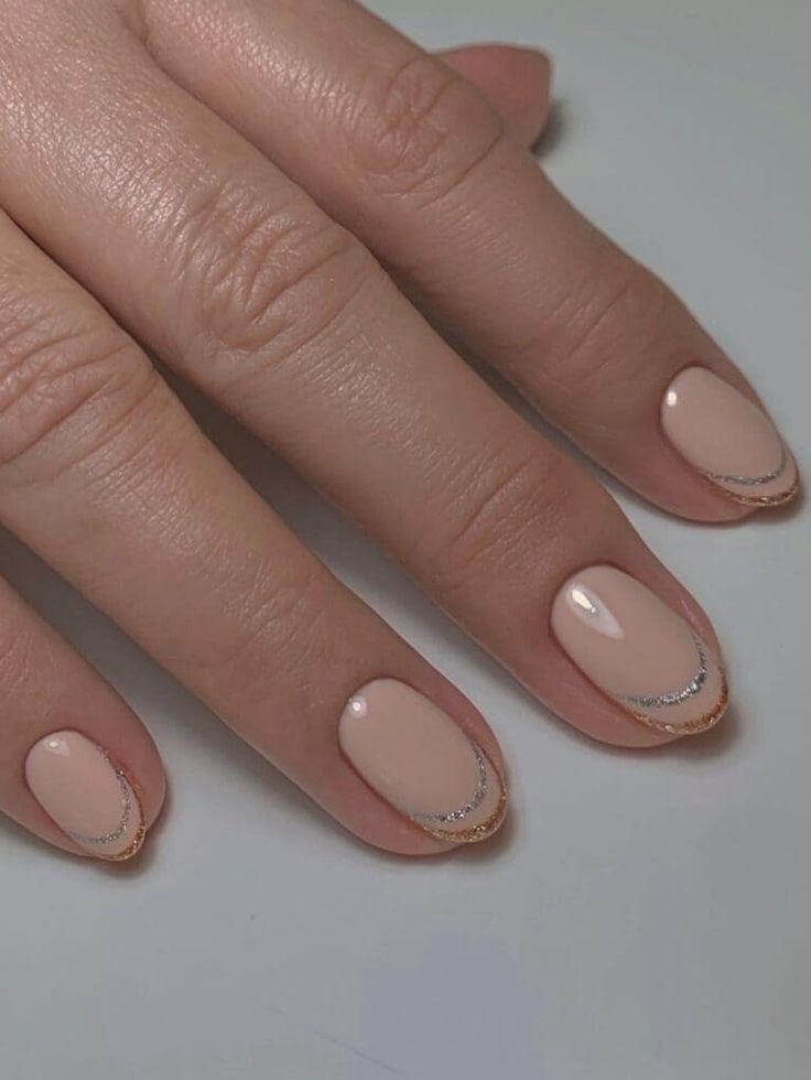 Sophisticated Minimalist Nude Nail Design with Glossy Finish and Delicate Silver Accents.