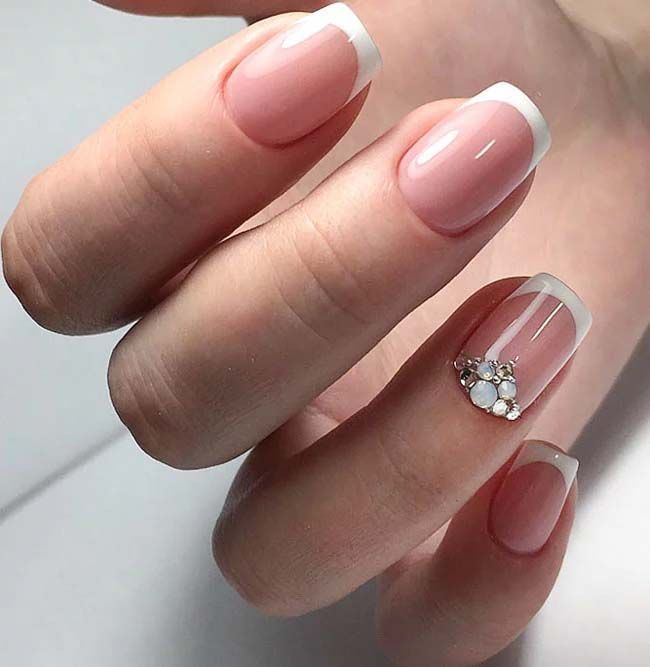 Timeless French Manicure with Glamorous Gemstone Accent.