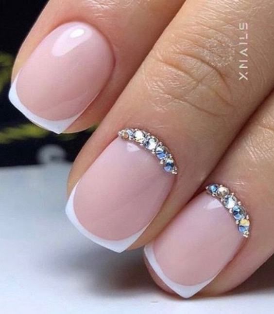 Chic Nude French Tip Nails with Delicate Crystal Accents for Effortless Elegance.