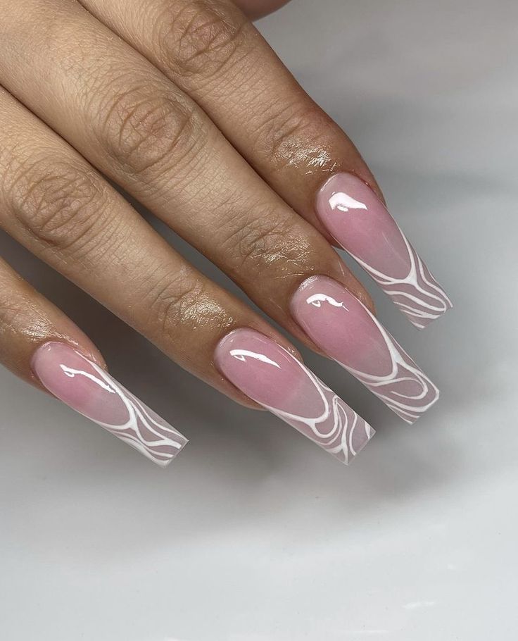 Sophisticated Soft Pink Nail Design with Intricate White Swirls and Glossy Finish.