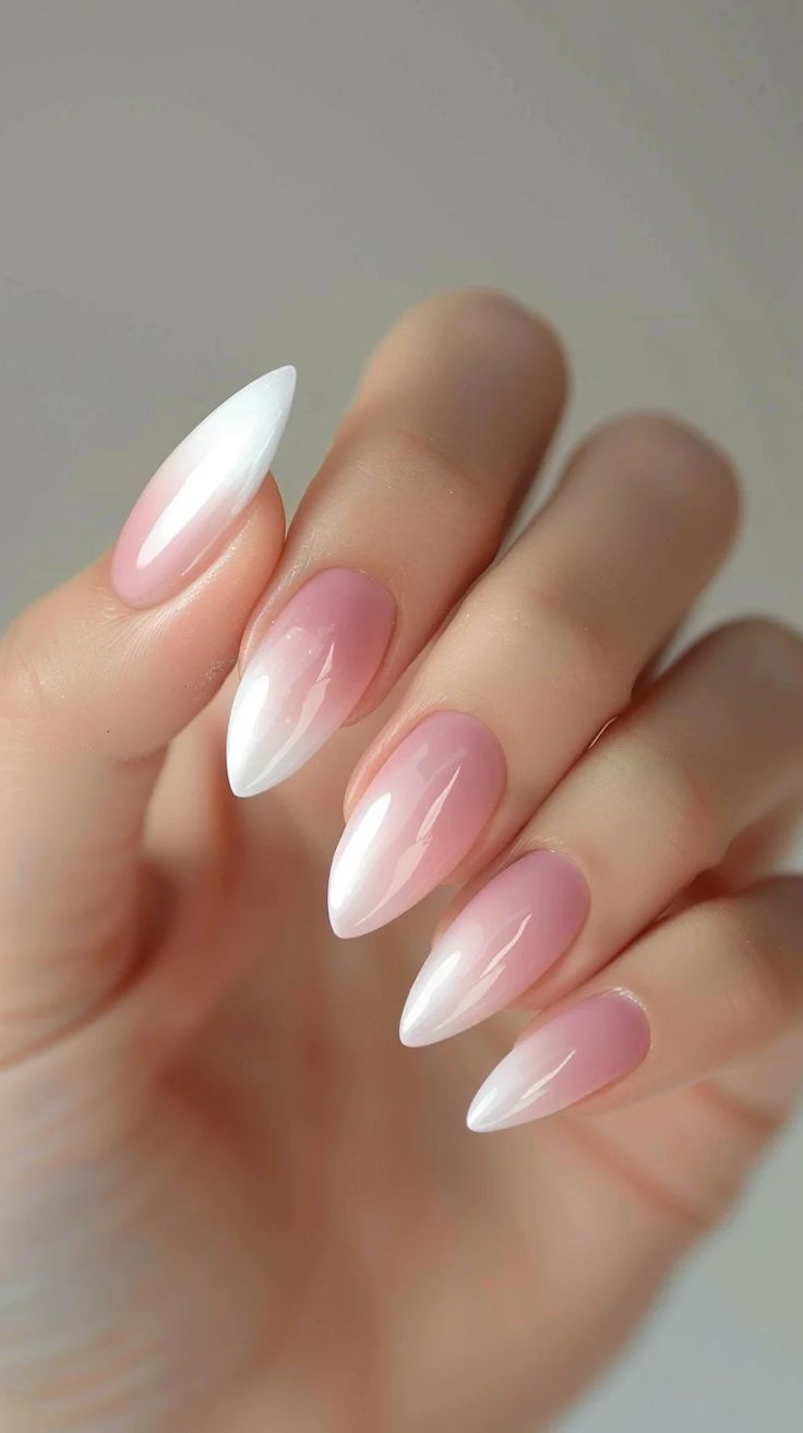 Chic Almond-Shaped Nail Art: Soft Pink Gradient with Elegant White Tips.