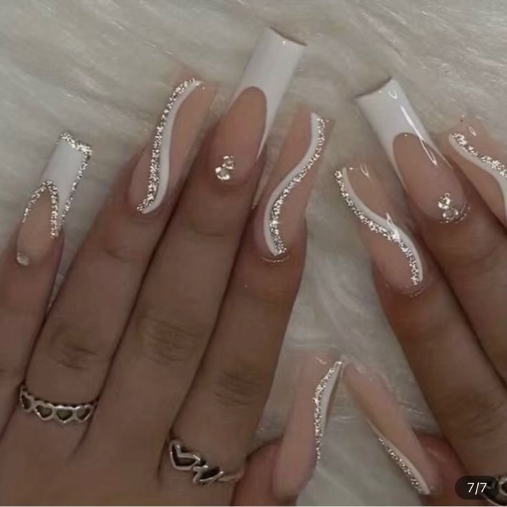 Sophisticated Nude and White Nail Design with Elegant Silver Detailing.