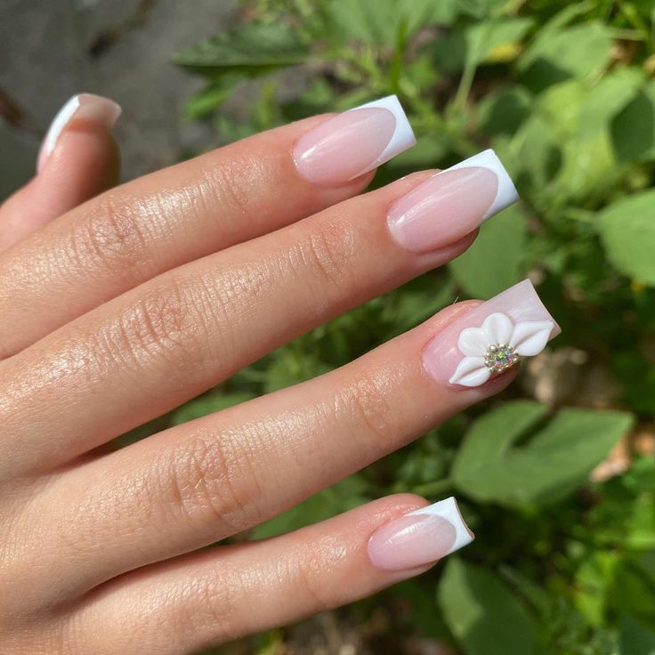 Sophisticated French Manicure with Floral Accent Design.