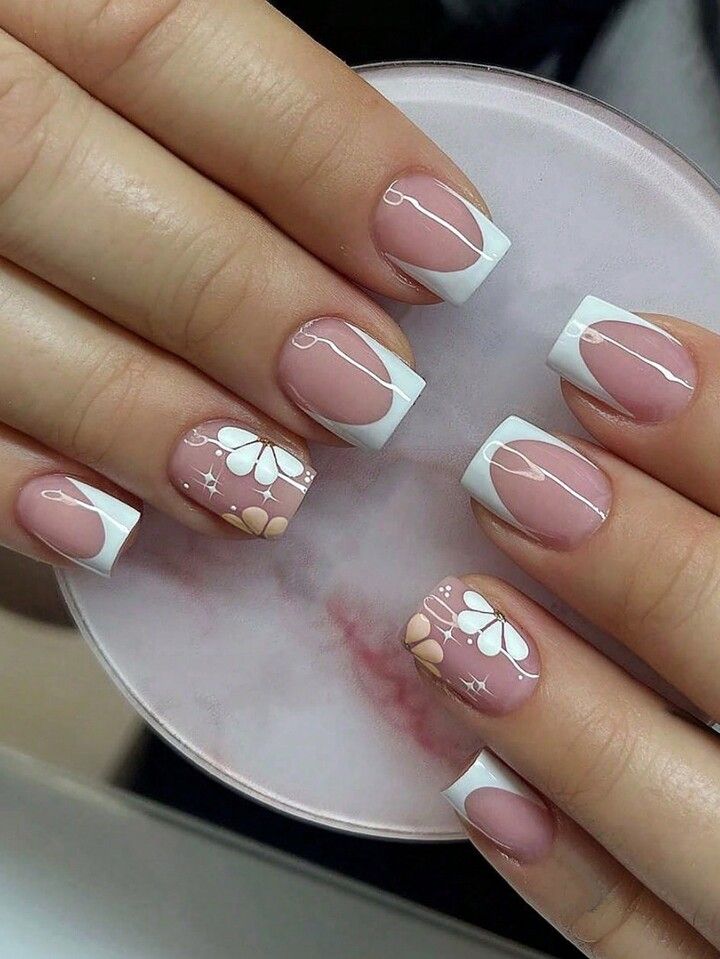 Elegant Soft Pink and White Tip Nail Design with Floral Patterns and Abstract Lines.